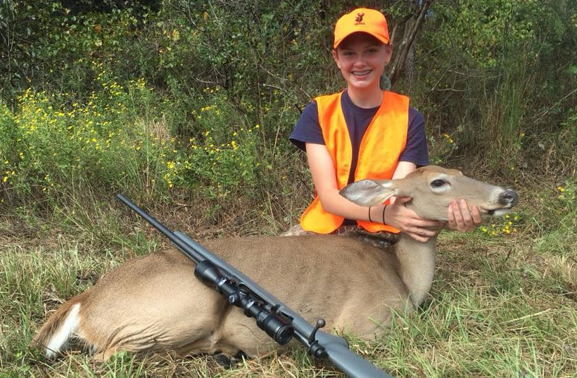 The author's young daughter with a doe taken on public land.