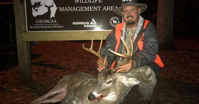 Hunter with a big public land buck.