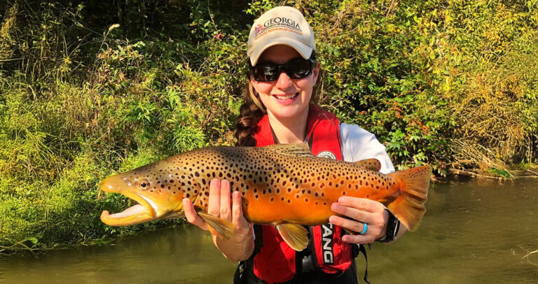 A Georgia DNR employee with a large trout.