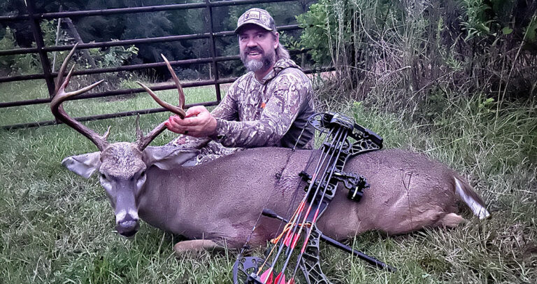 The author with a buck he harvested with a bow.