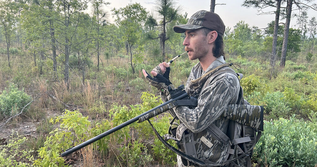 A hunter using a wingbone turkey call.